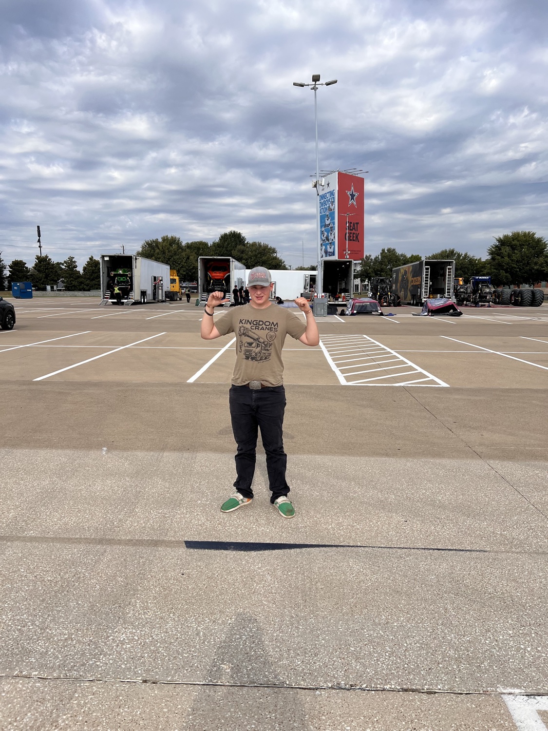 Kingdom Cranes crew member wearing a company shirt at AT&T Stadium during an event setup