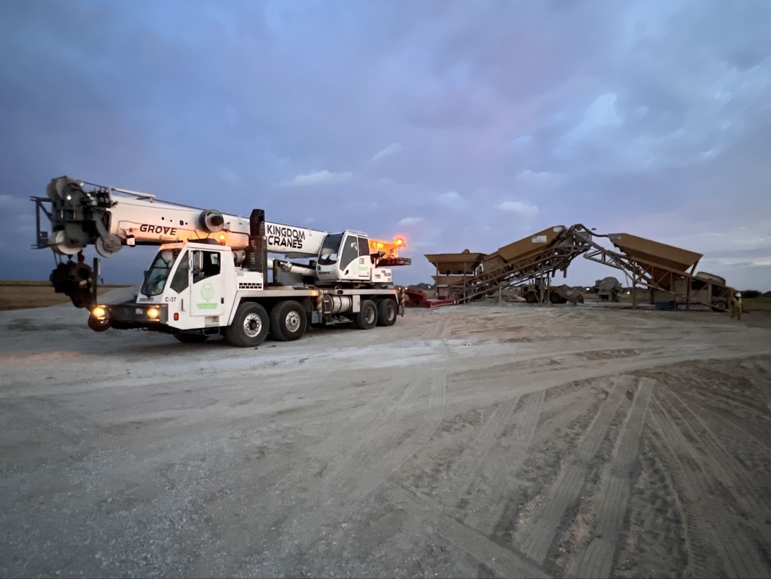 Kingdom Cranes Grove truck crane set up at an industrial plant at dusk